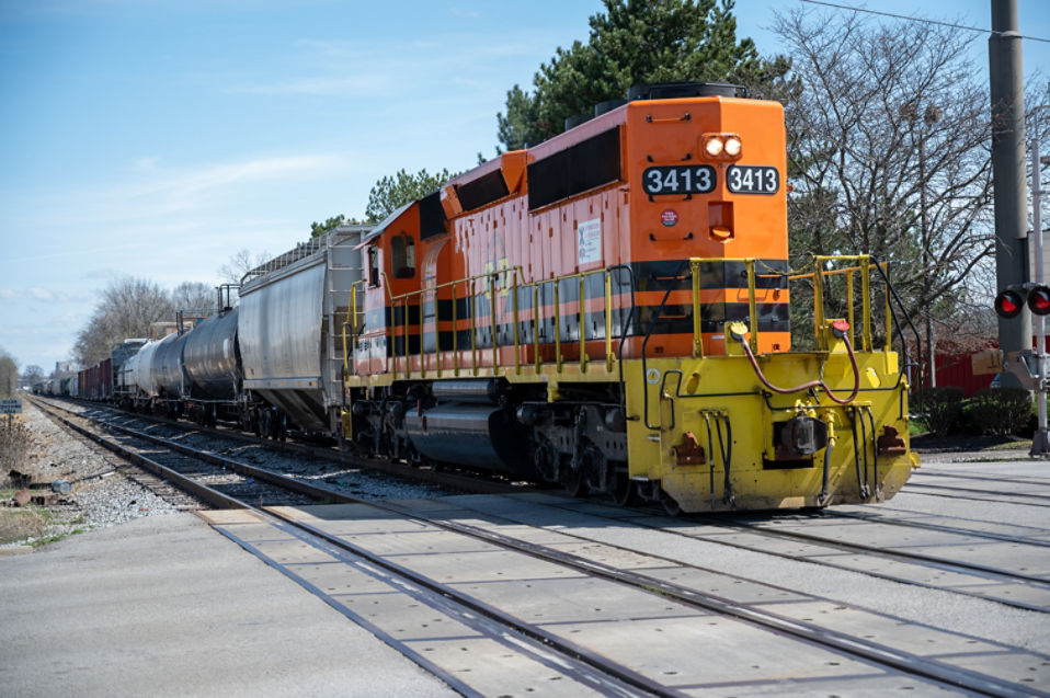 Train crossing a track and blocking the vehicular intersection