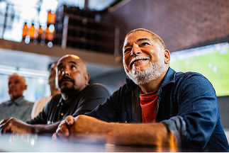 Two men sitting at a bar looking up