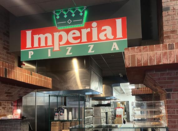 Customers celebrating and cheering with TV screens lining the walls of a restaurant or bar