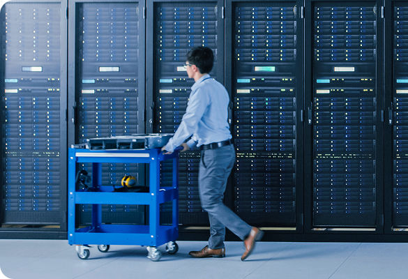 Man pushing a cart in a server room