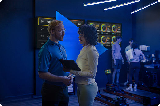 Spectrum employee speaking with a small business owner at a fitness center