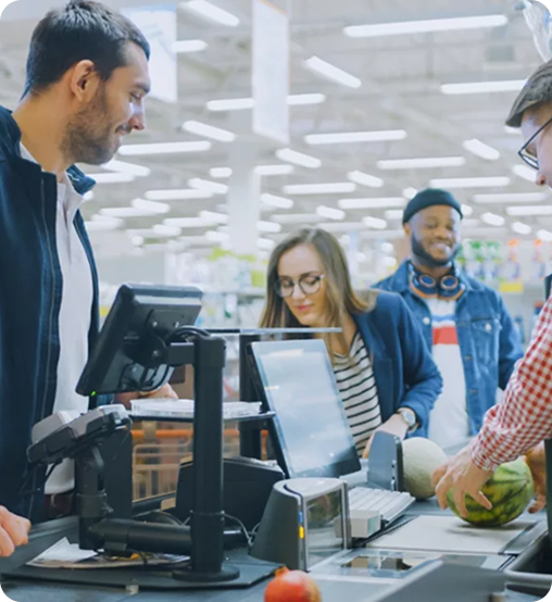 At the Supermarket: Checkout Counter Professional Cashier Scans Groceries and Food Items. Clean Modern Shopping Mall.