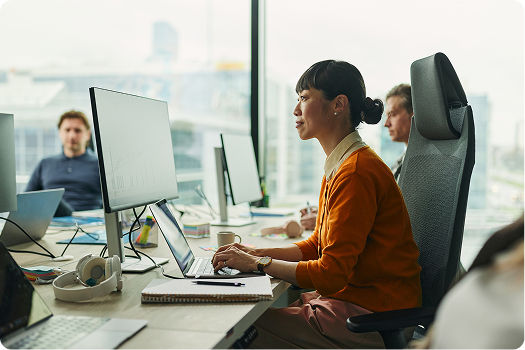 Woman working in a company on a laptop