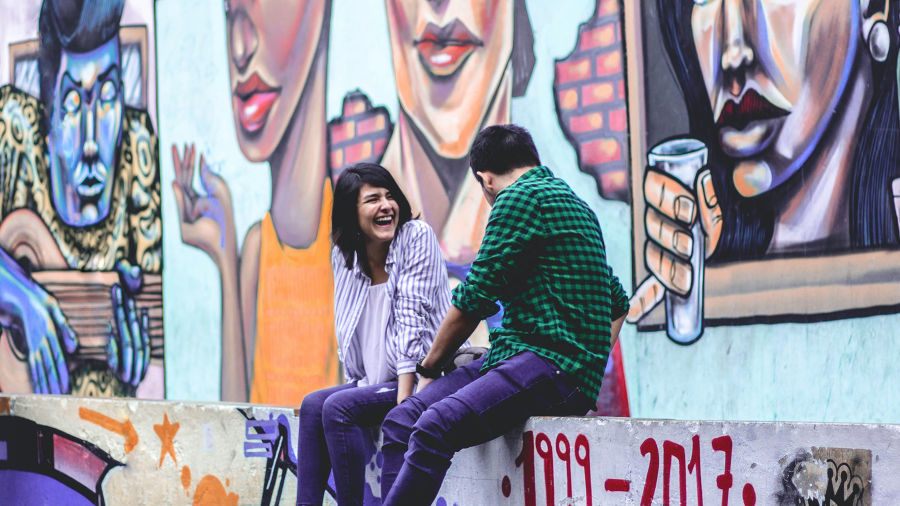 people talking with street art in background